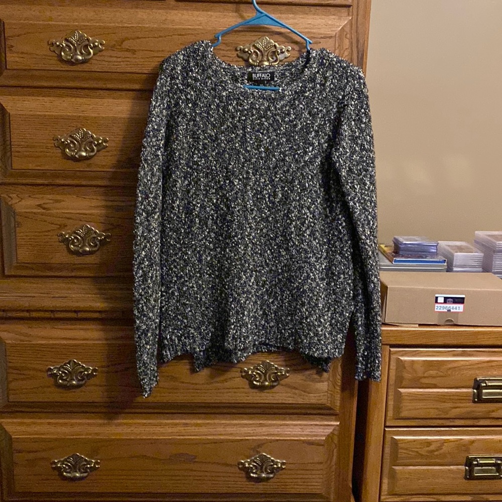 Woman’s charcoal gray sweater.